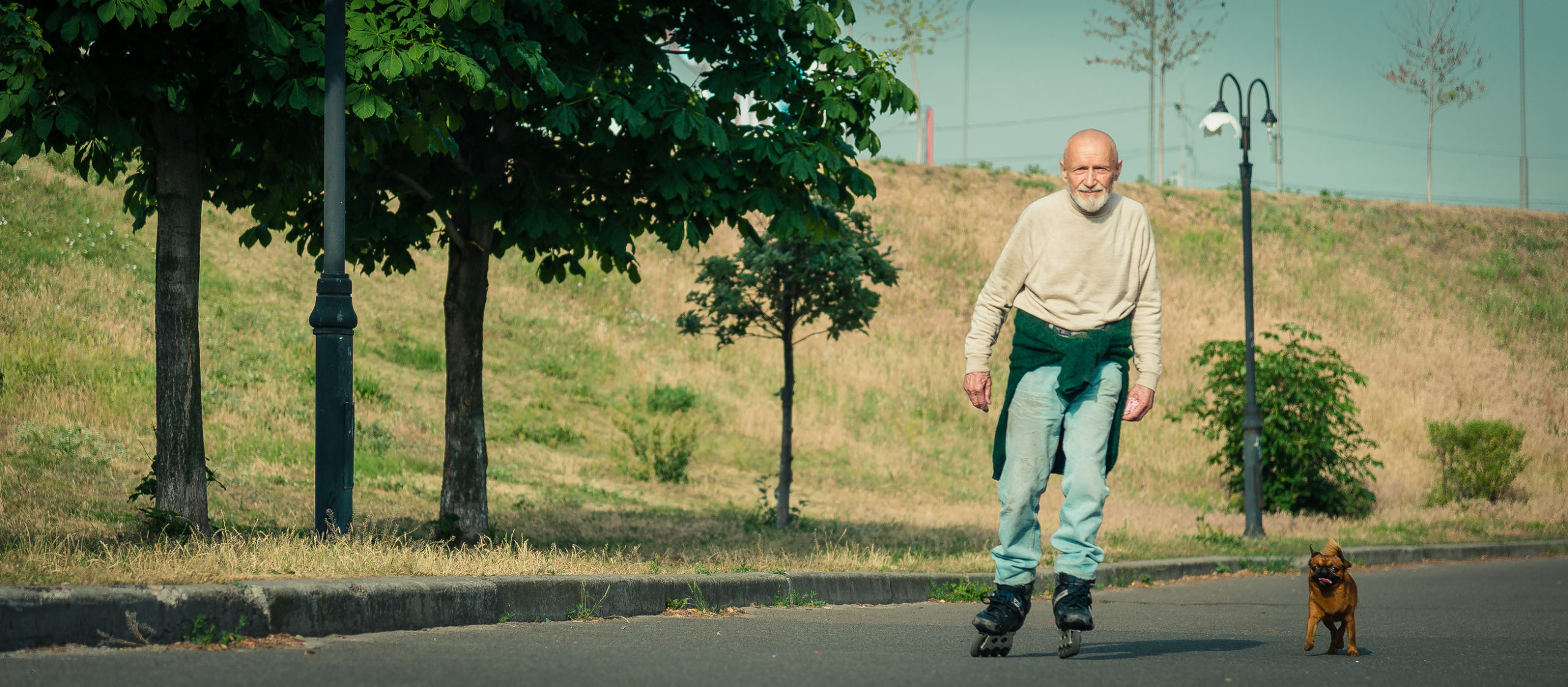 Grandpa rolls on roller with a dog of the Griffon breed